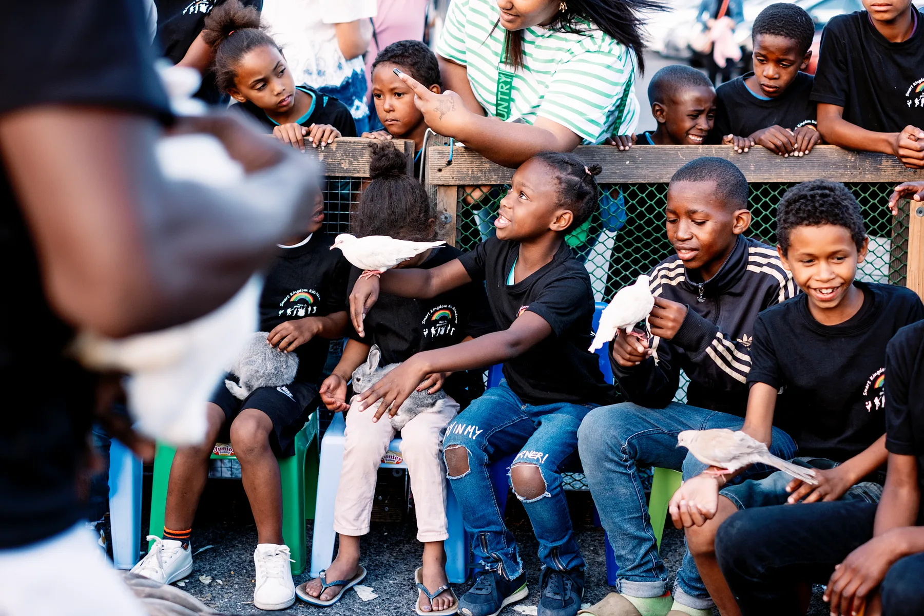 A group of SKKA children hold doves and rabbits at the community Christmas gathering in Lavender Hill.